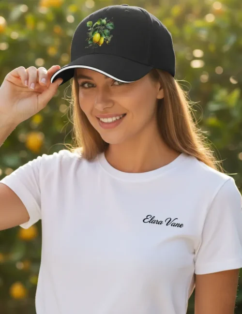 A person wearing the Elara Vane lemon art cap at a sun-drenched outdoor