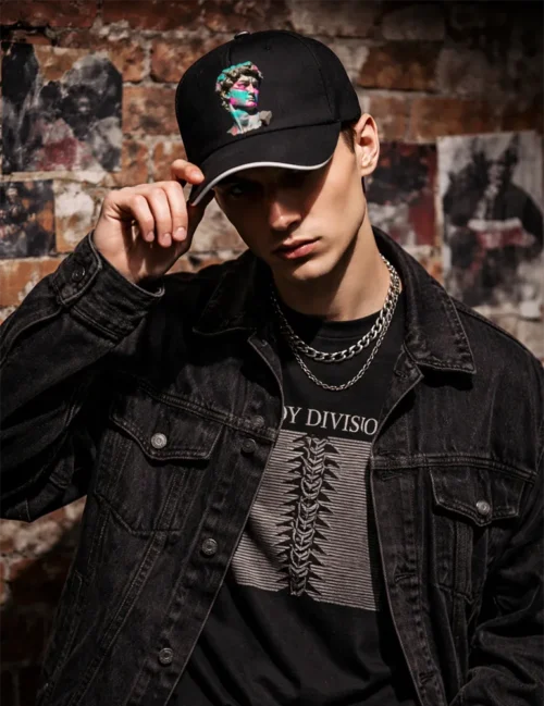 A streetwear collector in an industrial Berlin alleyway wearing the Urban Anthem art cap